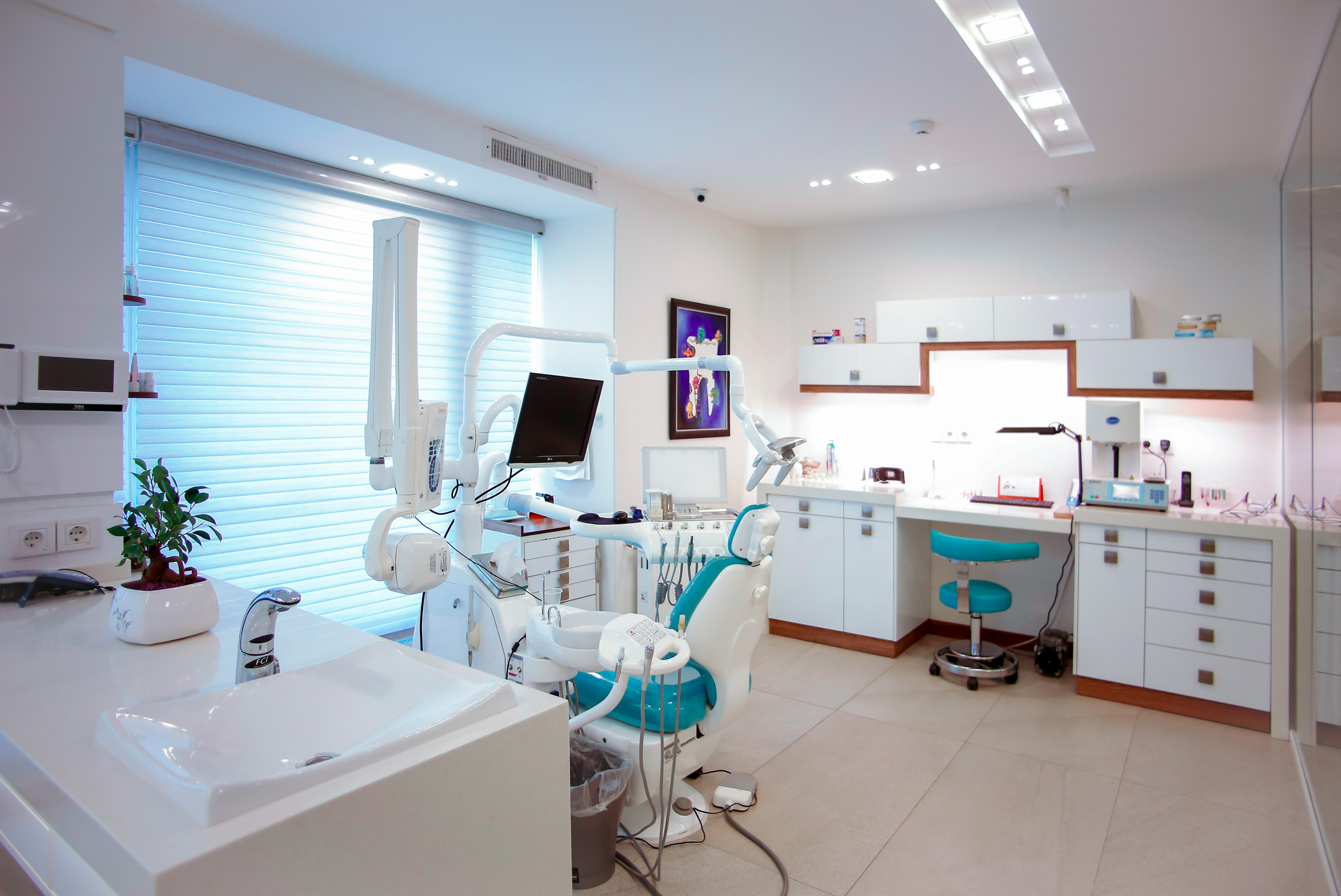 Dental construction blog header featuring modern dental office interior with equipment and professional lighting