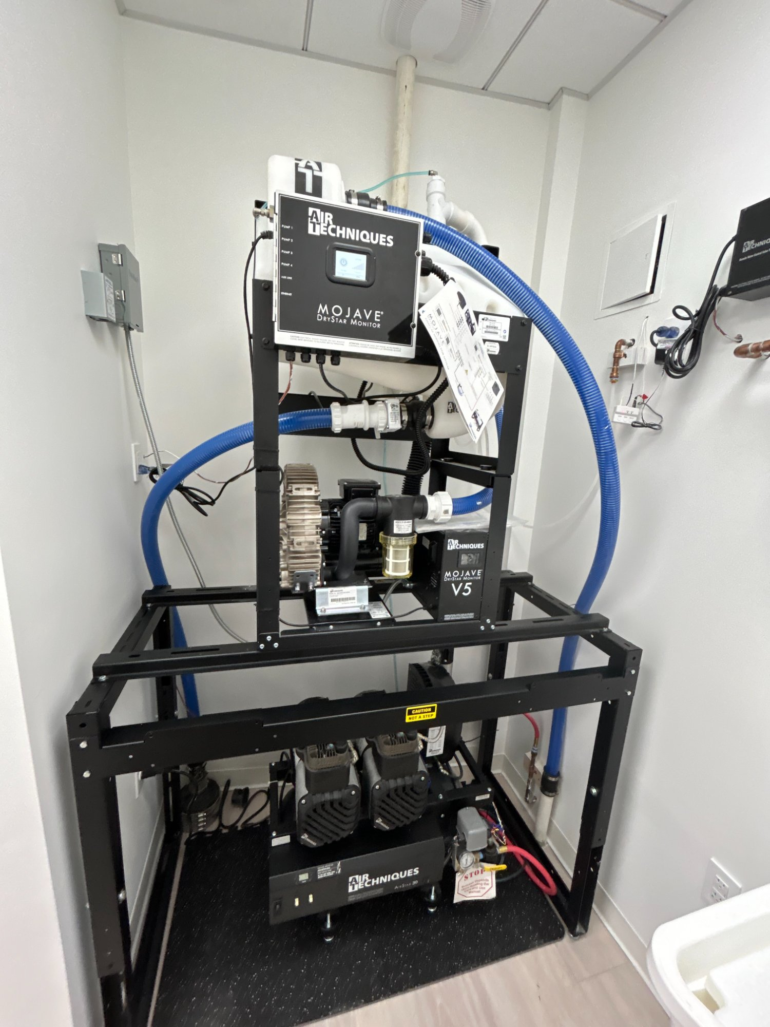 Air Techniques Mojave DryStar dry vacuum system and AirStar compressor installed in mechanical room