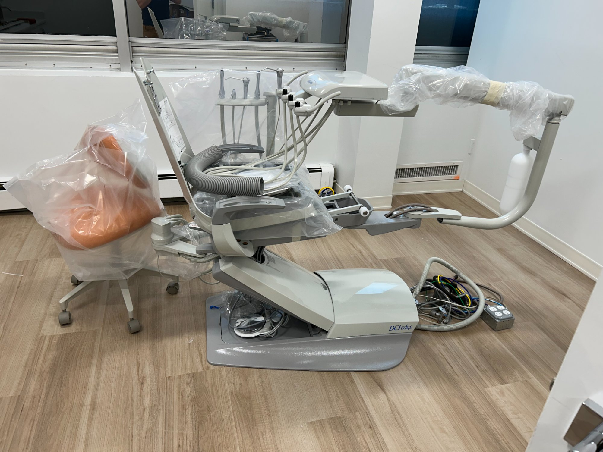 DCI Edge dental chair with delivery system being installed and connected in new operatory