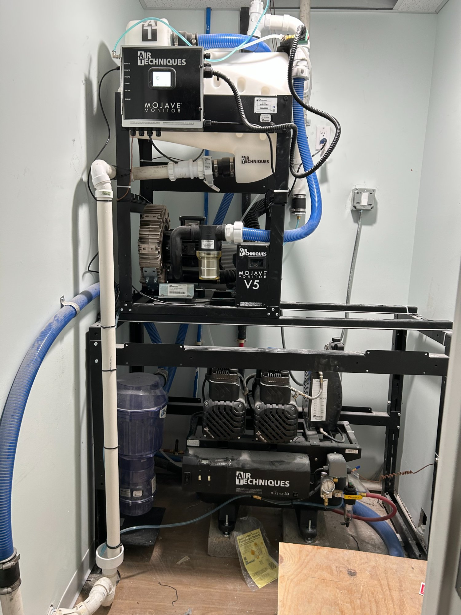 Complete Air Techniques mechanical room with Mojave Monitor, V5 dry vacuum, and AirStar 30 compressor