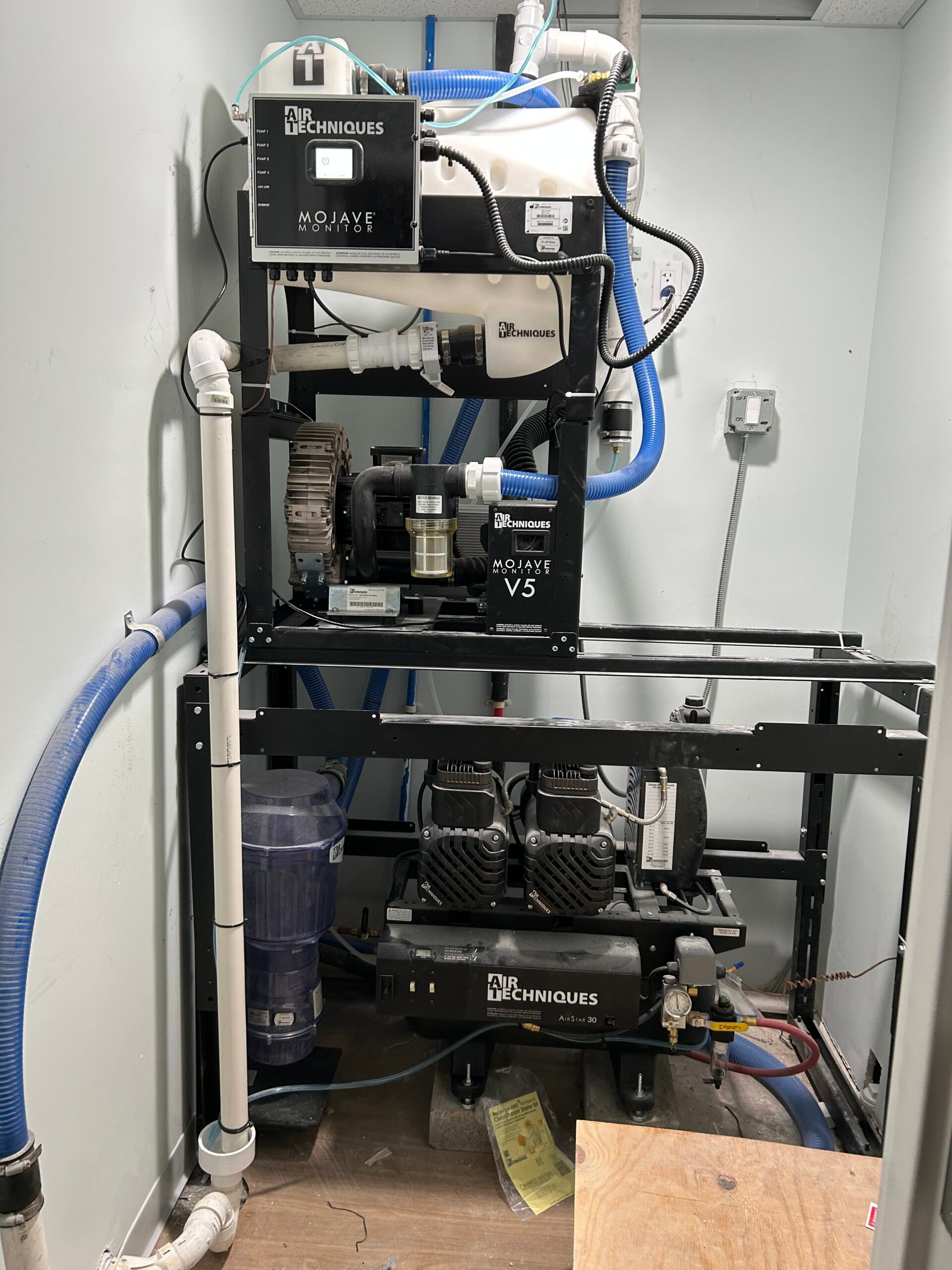 Dental mechanical room upgrade in Westchester showing compressed air, suction, and plumbing infrastructure installation by GCMM Dental Construction